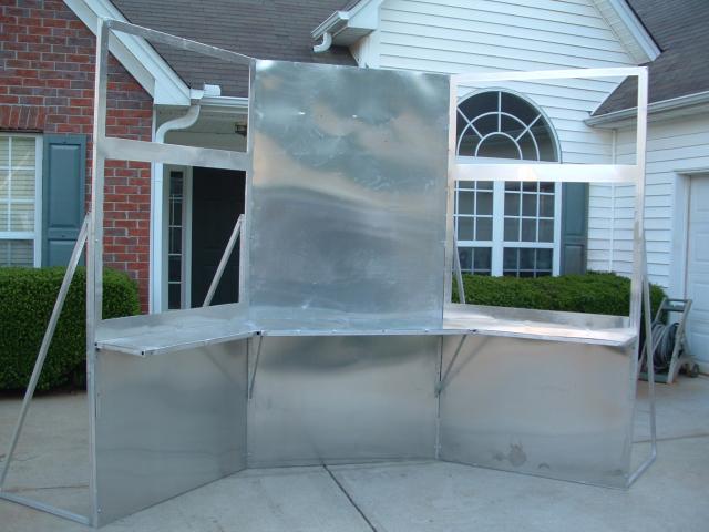 Custom fabricated aluminum trade show display for contractor with folding leaves