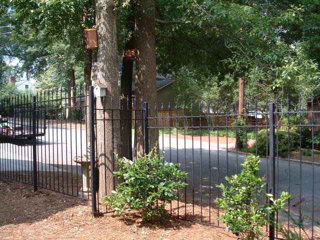 Wrought iron fence terraced for slope and unique perimeter