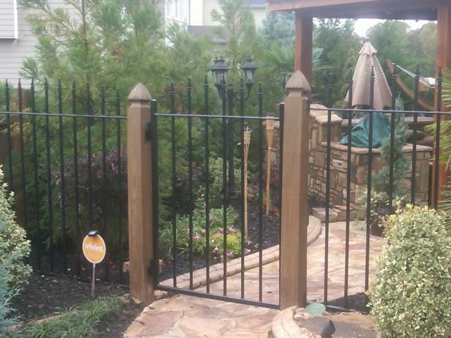 Custom wrought iron fence and gate with arched pickets